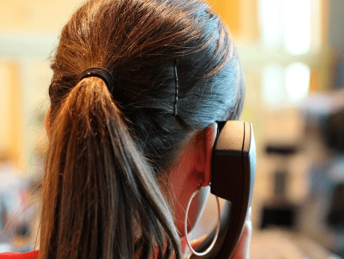 support person holding phone and listening 